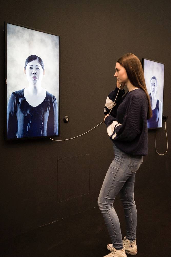Mehrere Screens zeigen  Männer und Frauen unterschiedlicher Herkunft und Alters beim Singen von „Stille Nacht!“. Alle zwei Takte wechseln beziehungsweise „Morphen“ diese SängerInnen. © Anita Ledersberger